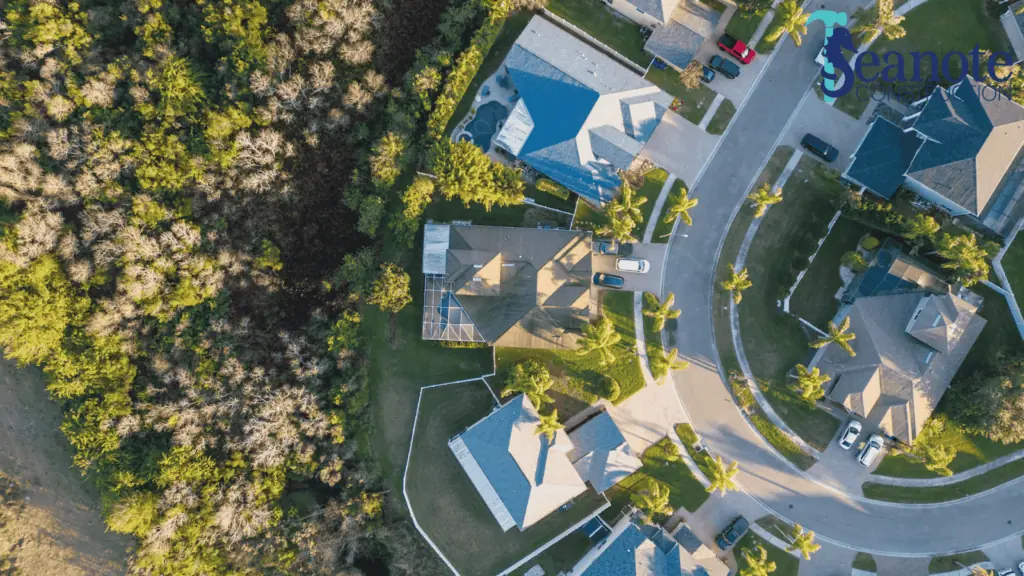Aerial view of suburban neighborhood and forest.