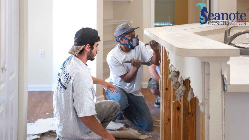 Seanote workers renovating a kitchen with safety gear.