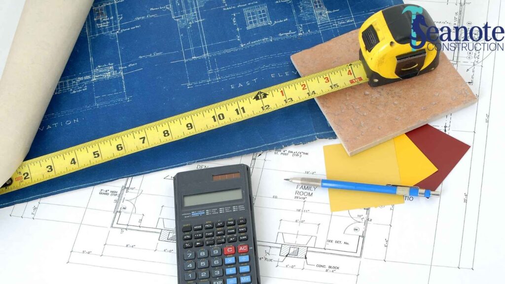 Construction blueprints, measuring tape, calculator, design materials.