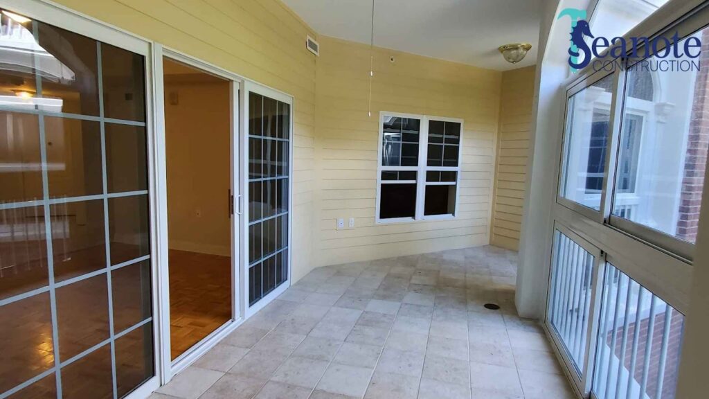 Sunroom with sliding glass doors and tiled floor.