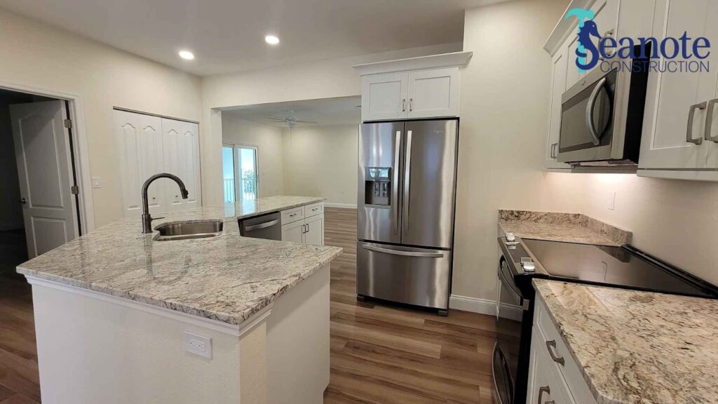 Modern kitchen with stainless steel appliances and granite countertops.