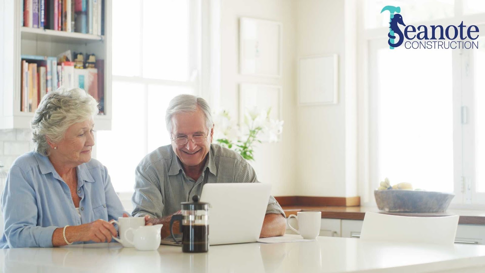 Older couple smiling at a kitchen counter