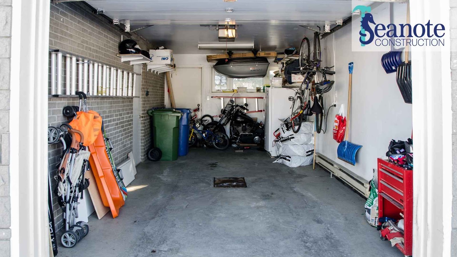 Organized garage with tools, bikes, and storage.