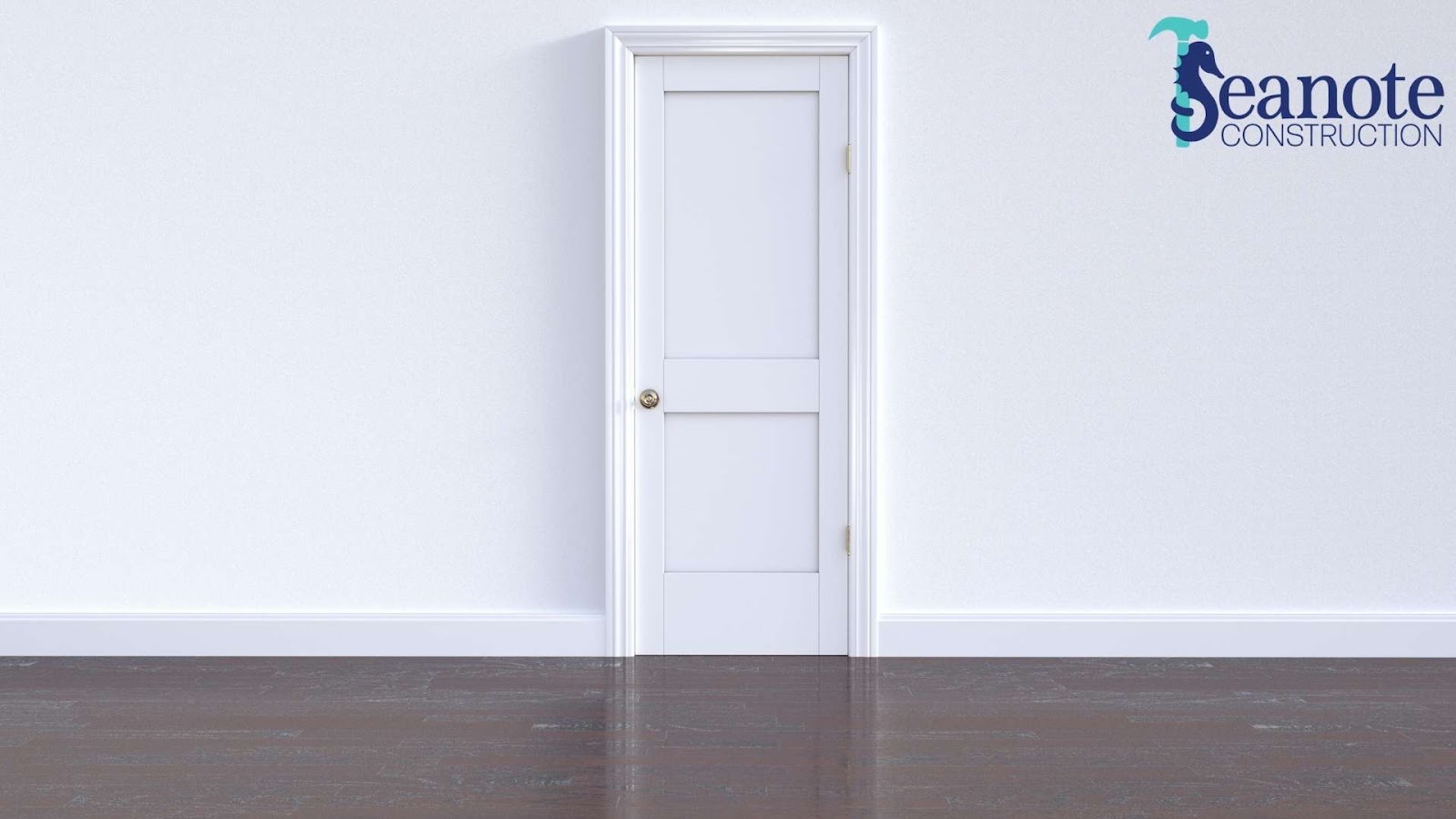 White door on blank wall with hardwood floor.