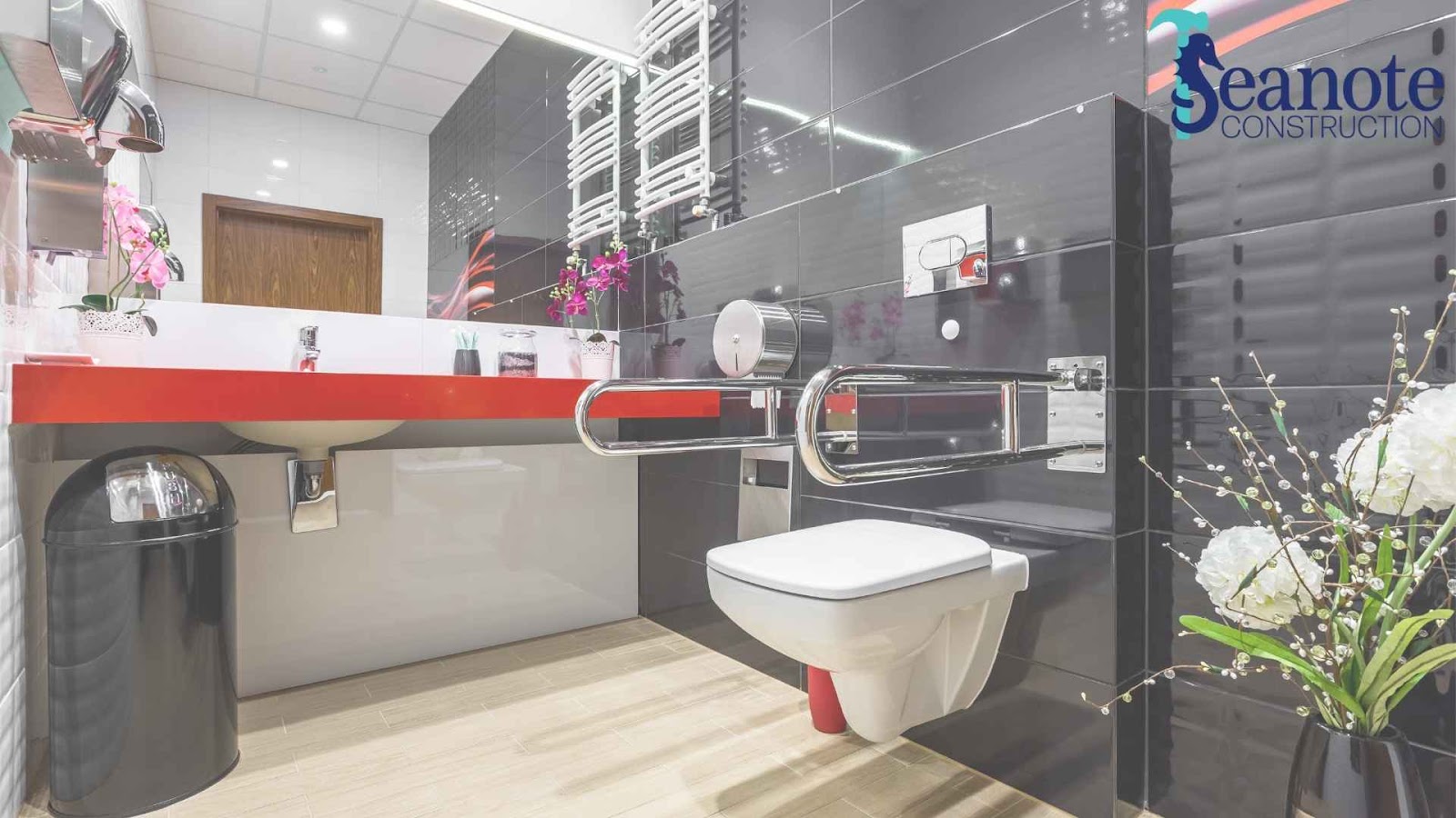 Modern accessible bathroom with red countertop and flowers.