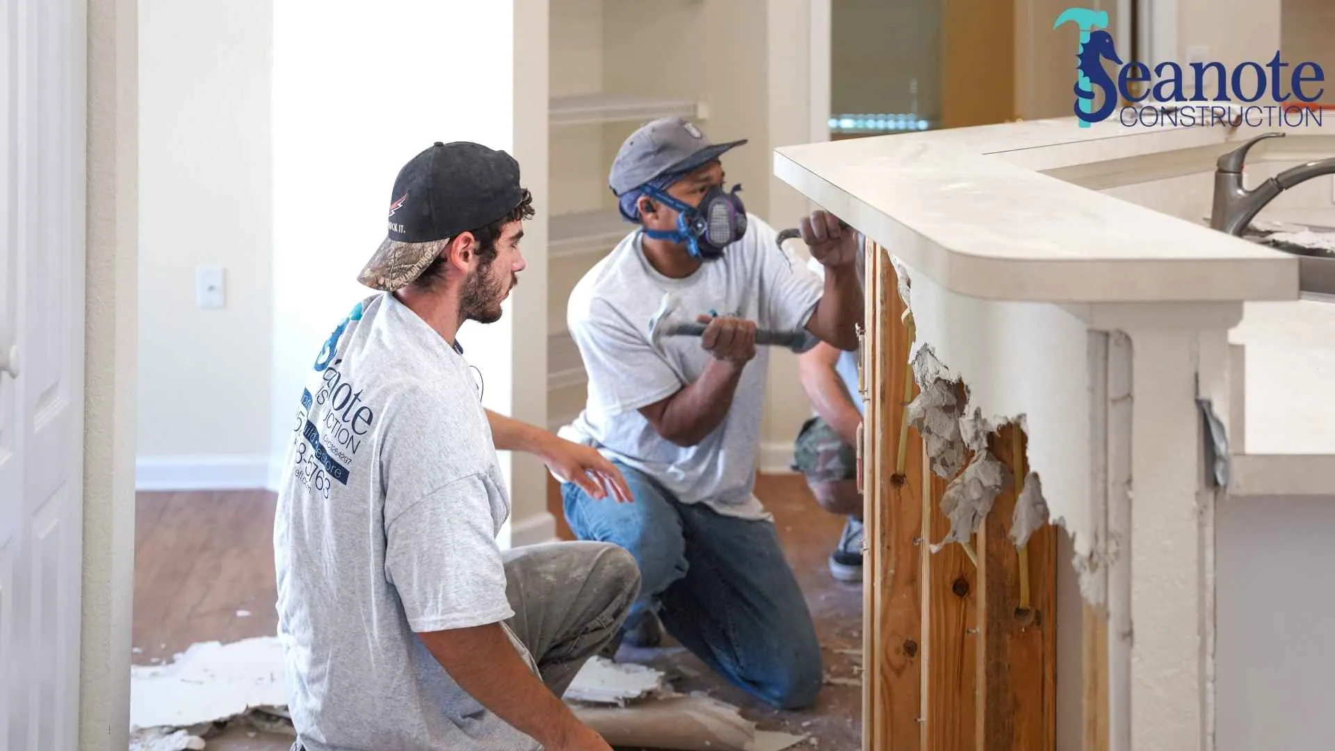 Construction workers renovating kitchen countertop.