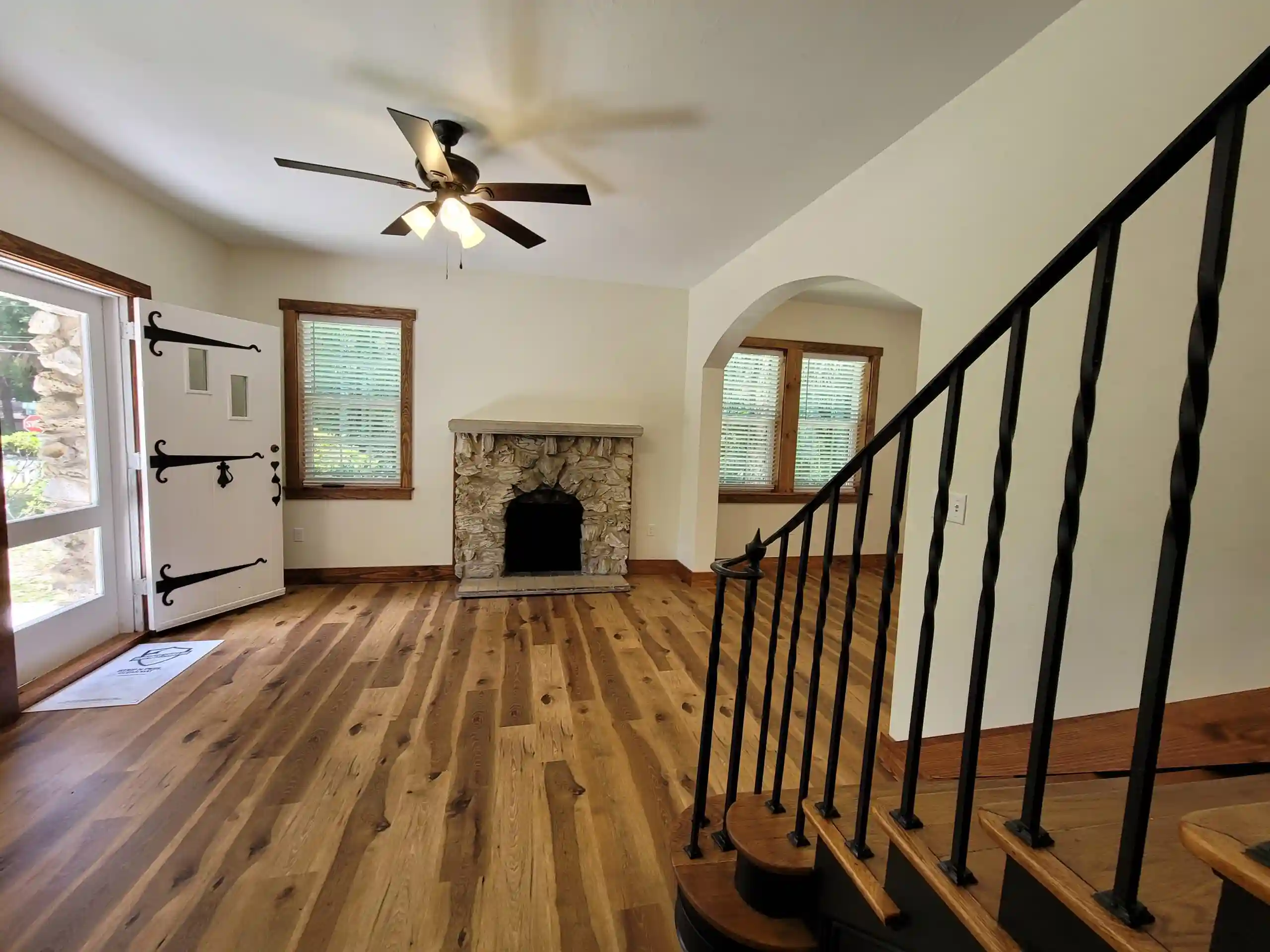 Bright living room with fireplace and wooden floors