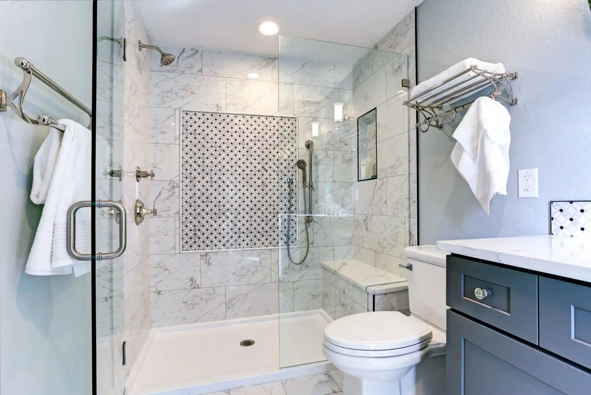 Modern bathroom with glass shower and marble tiles
