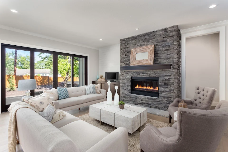 Modern living room with stone fireplace and sofas