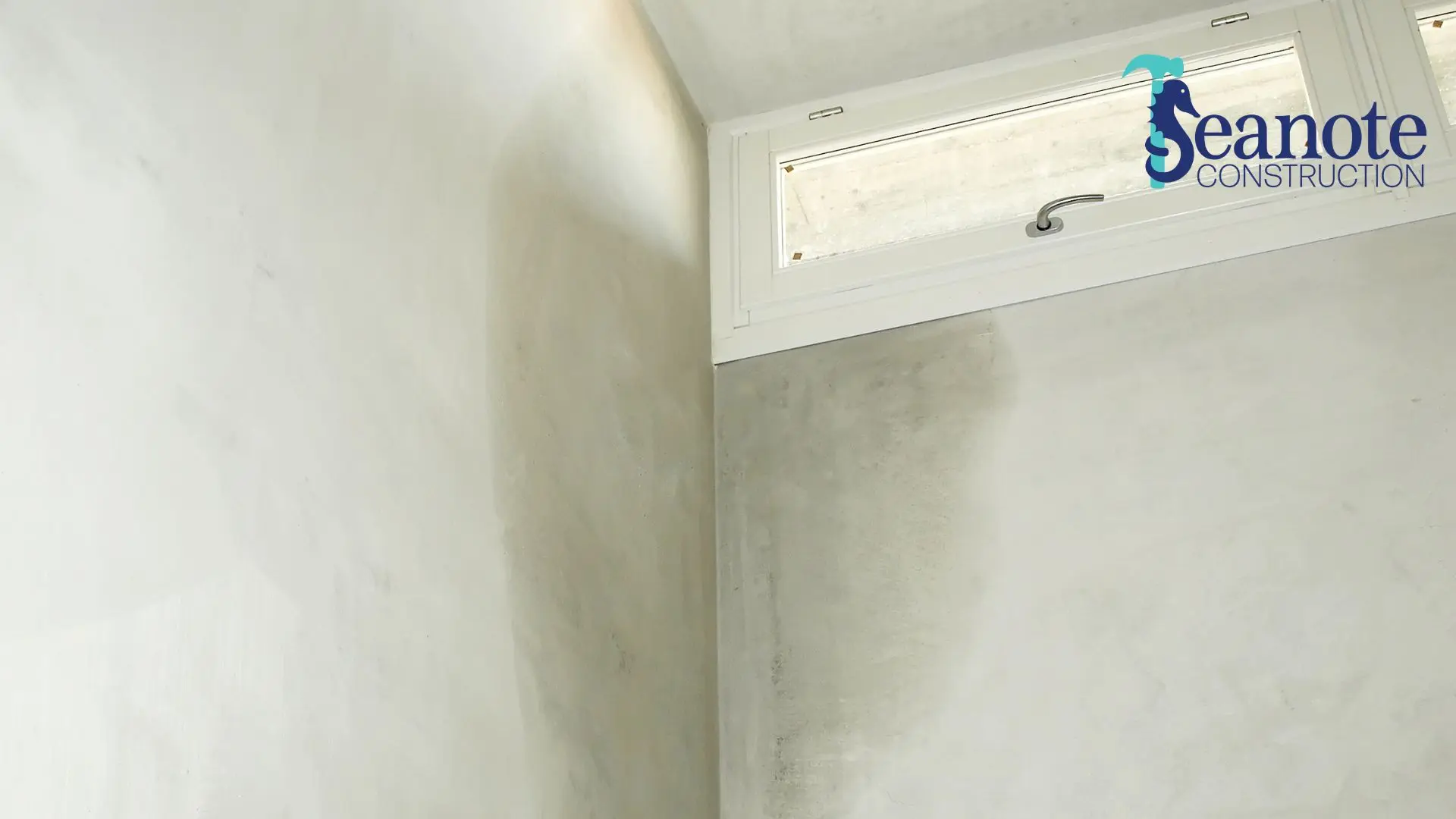 Mold and damp stains on interior wall corner of bathroom