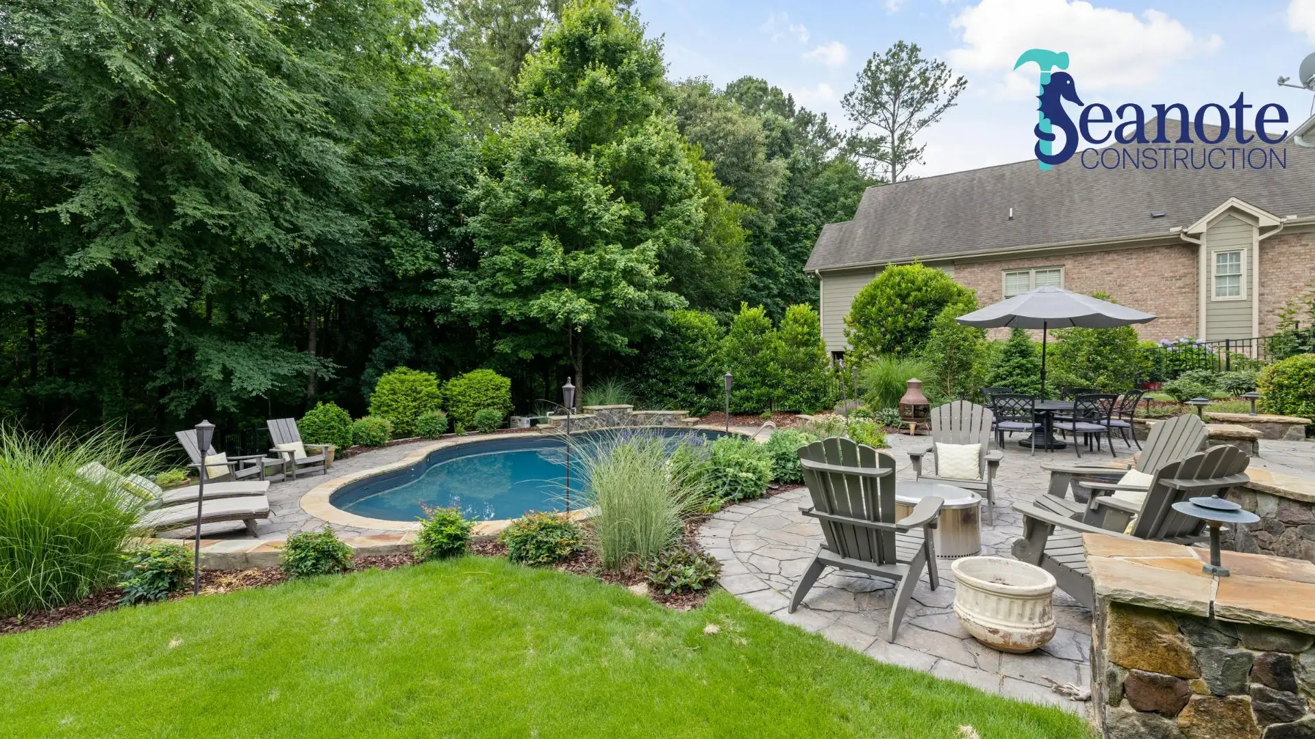 Landscaped backyard with pool and stone patio