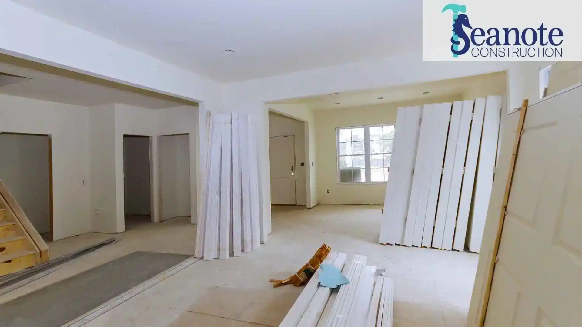Interior home renovation with stacked trim boards and unfinished rooms Seanote